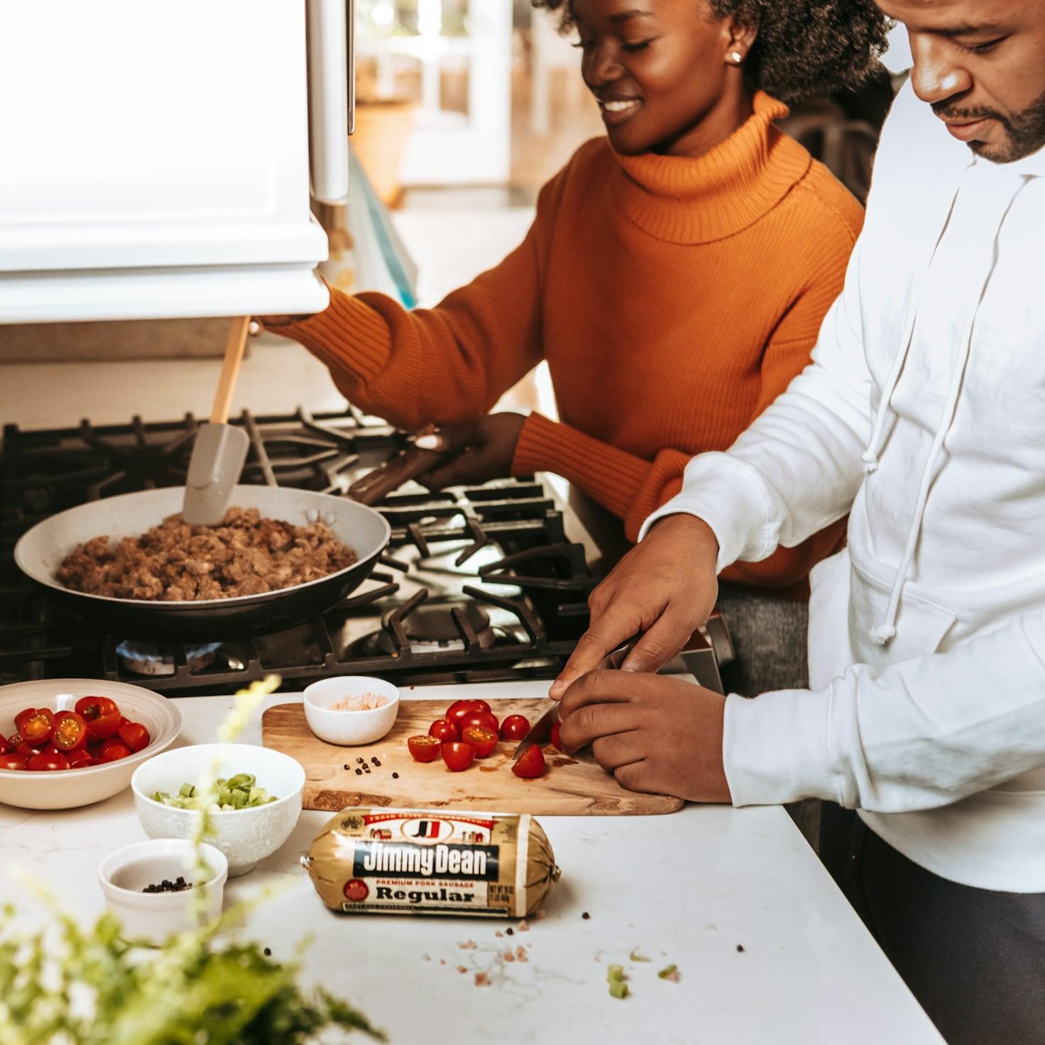 Community members collaborating in a modern kitchen space, sharing recipes and cooking techniques